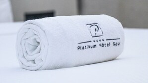 A rolled white towel with a logo and text indicating 'Platinum Hotel 500'.