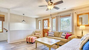 A room with a ceiling fan, a sofa, a coffee table, and a bed. - Balsam View (Waynesville)