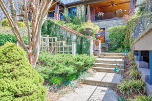 A house with a stone facade, a wooden staircase, and a balcony with railings. - English Roses (Lake Junaluska)