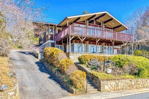 A two-story building with a balcony, stone steps, and surrounding greenery. - Morris Villa Lower (Lake Junaluska)