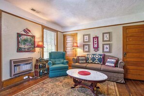 A living room with a sofa, armchair, and a coffee table. - Lyons Den Upper (Lake Junaluska)