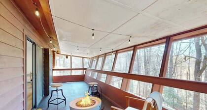 Updated tree-lined cabin with mountain view, and screened-in deck.
