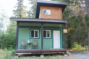 A small cabin with a porch, two windows, and a door. - Newly built spacious 2BDR cabin - 6A (Terrace)
