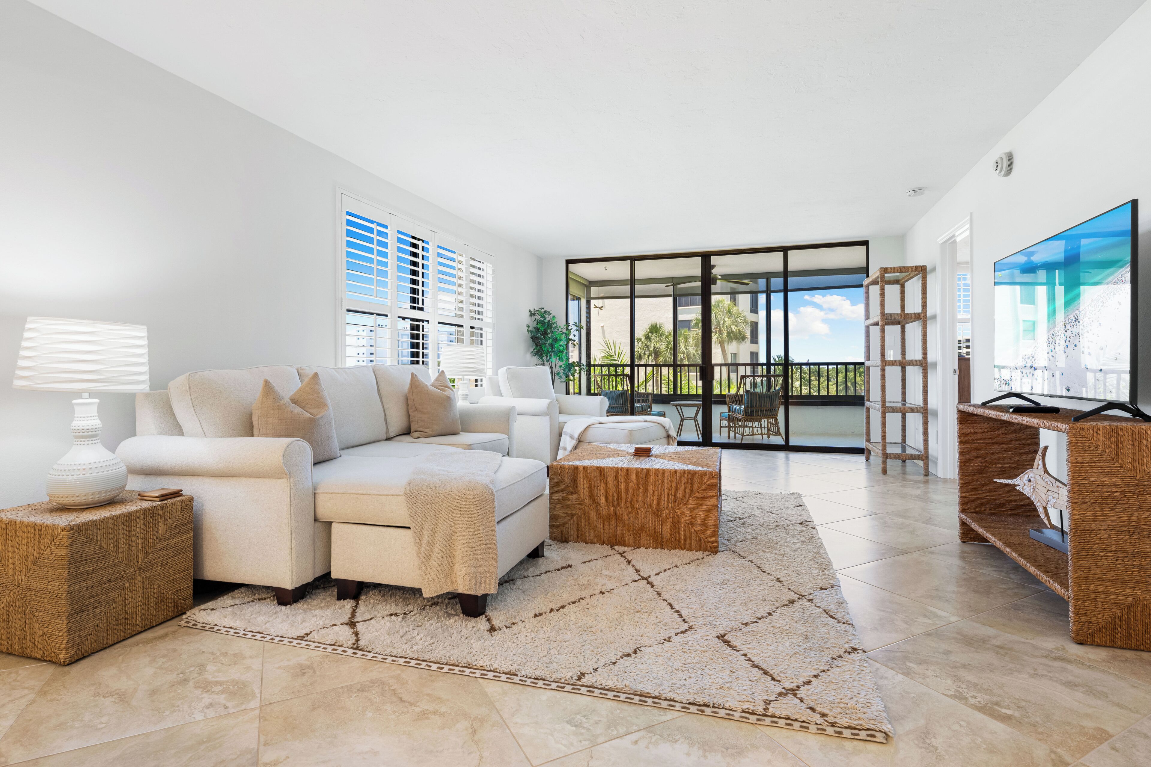 A modern living room with a sofa, coffee table, and TV.