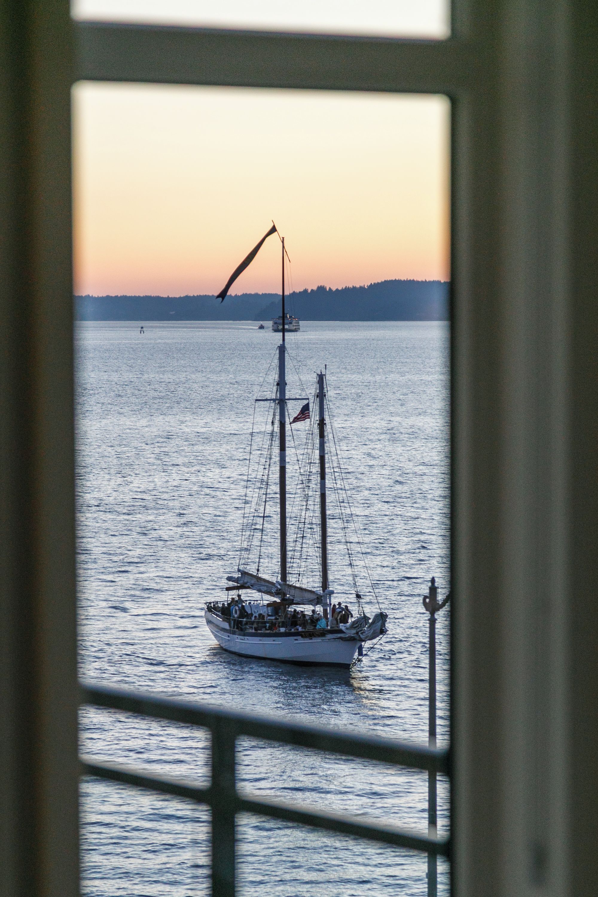 A boat on calm water with a clear sky in the background.