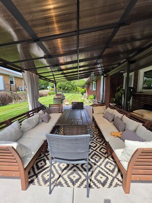 An outdoor patio with a covered seating area, a grill, and a view of the backyard. - Spacious 4 bdr house in Medinah within walking distance of Medinah Country Club (Medinah)