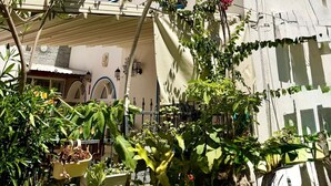 A building with a sign reading 'KALE OTEL' and a balcony with plants. - Kale Otel Bodrum (Bodrum)