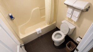 A bathroom with a bathtub, toilet, and a towel rack. - Deerfield Inn & Suites Steele Near Blytheville I 55 (Steele)