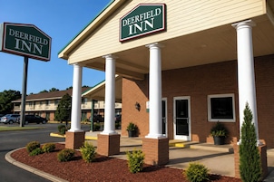 A Deerfield Inn with a brick facade, white columns, and a covered entrance.