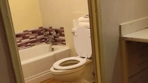 A bathroom with a toilet, a bathtub, and a shower. - Townhouse Motor Lodge Springfield Oh (Springfield)
