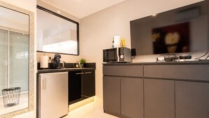 A modern kitchen with a built-in microwave, coffee machine, and a flat-screen TV. - Naturiste Cap d'Agde Port Nature 740 (Agde)