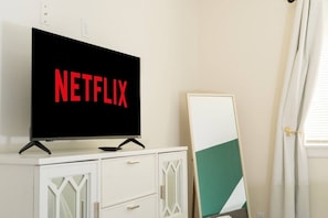 Una televisione con il logo Netflix su un mobile bianco.