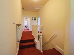 A carpeted staircase with white railings leading to a landing. - Beach Farmhouse (Bishops Castle)