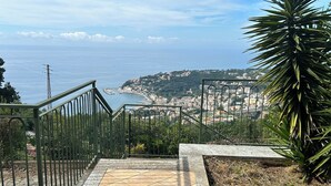 A staircase leading to a coastal view with a town in the background.