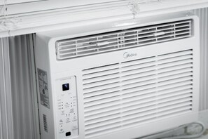Eine weiße Midea Klimaanlage mit Bedienfeld, das Temperatureinstellungen und verschiedene Modi anzeigt.