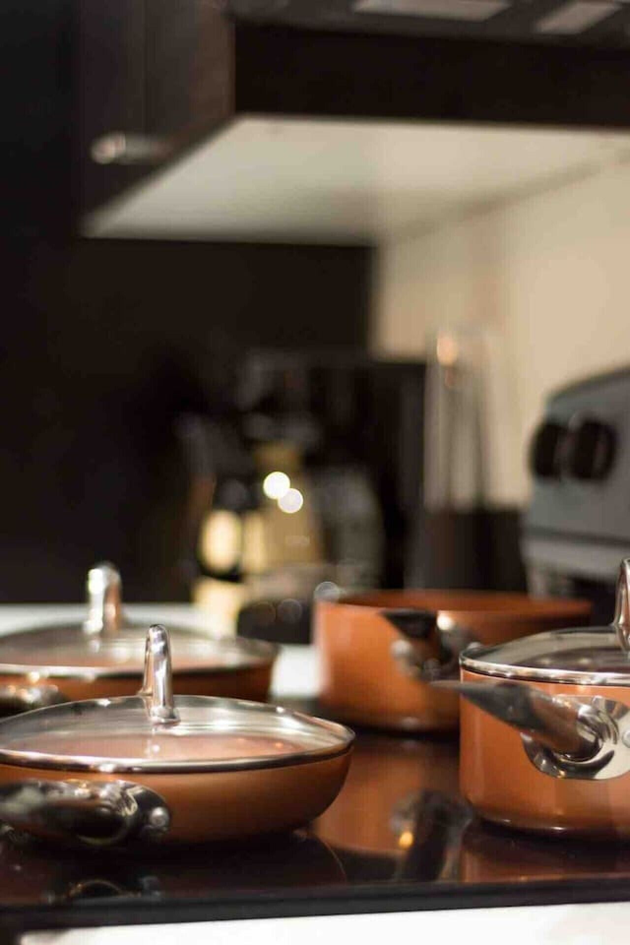 A kitchen with copper cookware on the counter.