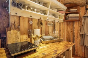 A wooden interior with shelves holding kitchenware and a sign labeled 'BULLERB'. - Holiday Home 'Glamping Cottage with Hot Tub' with Private Pool, Private Terrace and Wi-Fi (Hipstedt)