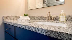 A bathroom with a granite countertop, a sink, a mirror, a faucet, and a bottle of hand soap. - ✅ RARE FIND! KING  Size Bed Central Mcallen WiFi ✅ (McAllen)