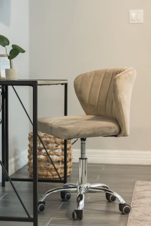 A modern office chair with a high backrest and a metallic base.