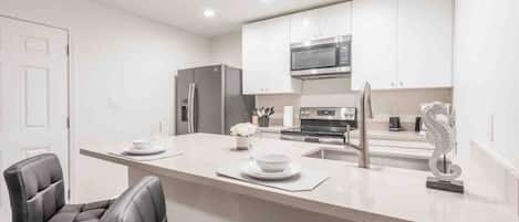 Coffee/tea maker, fridge, microwave, oven