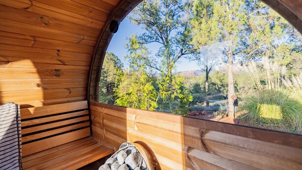 A wooden interior with a bench and a stone fireplace. - Luxury Sedona Views, Spa, Sauna, Cold Plunge (Sedona)
