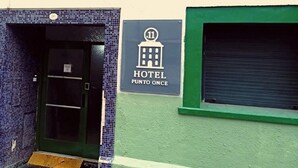 A hotel sign with a building icon and the name 'HOTEL PUNTO ONCE.' - Punto 11 (Buenos Aires)