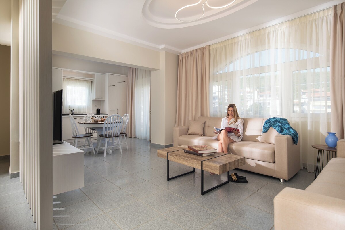 A modern living room with a sofa, coffee table, and a person reading a book.