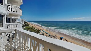 A beachfront hotel with balconies, a sandy beach, and the ocean. - Oceanside Retreat 804-805 (Ormond Beach)