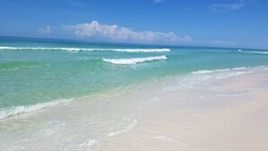 A beach with clear turquoise water and white sand.