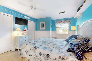 A bedroom with a bed, a dresser, a television, and a window with curtains. - Mallard Lakes - 158 Cardinal Ln (Selbyville)