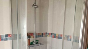 A glass-enclosed shower with a handheld showerhead and a wall-mounted faucet. - 2-room apartment in a large, quiet house with garden and shared spaces (Vence)