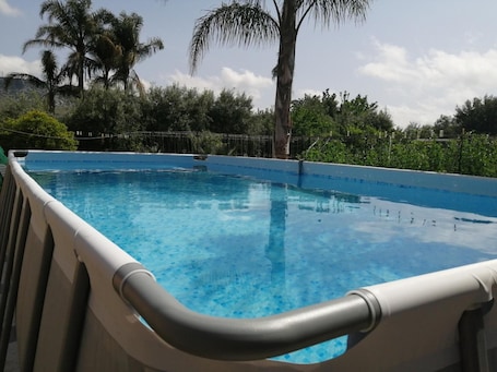 A clear blue swimming pool with a white poolside and a metal railing.. Villa Caterina with Mountain View, Wi-Fi and Air Conditioning