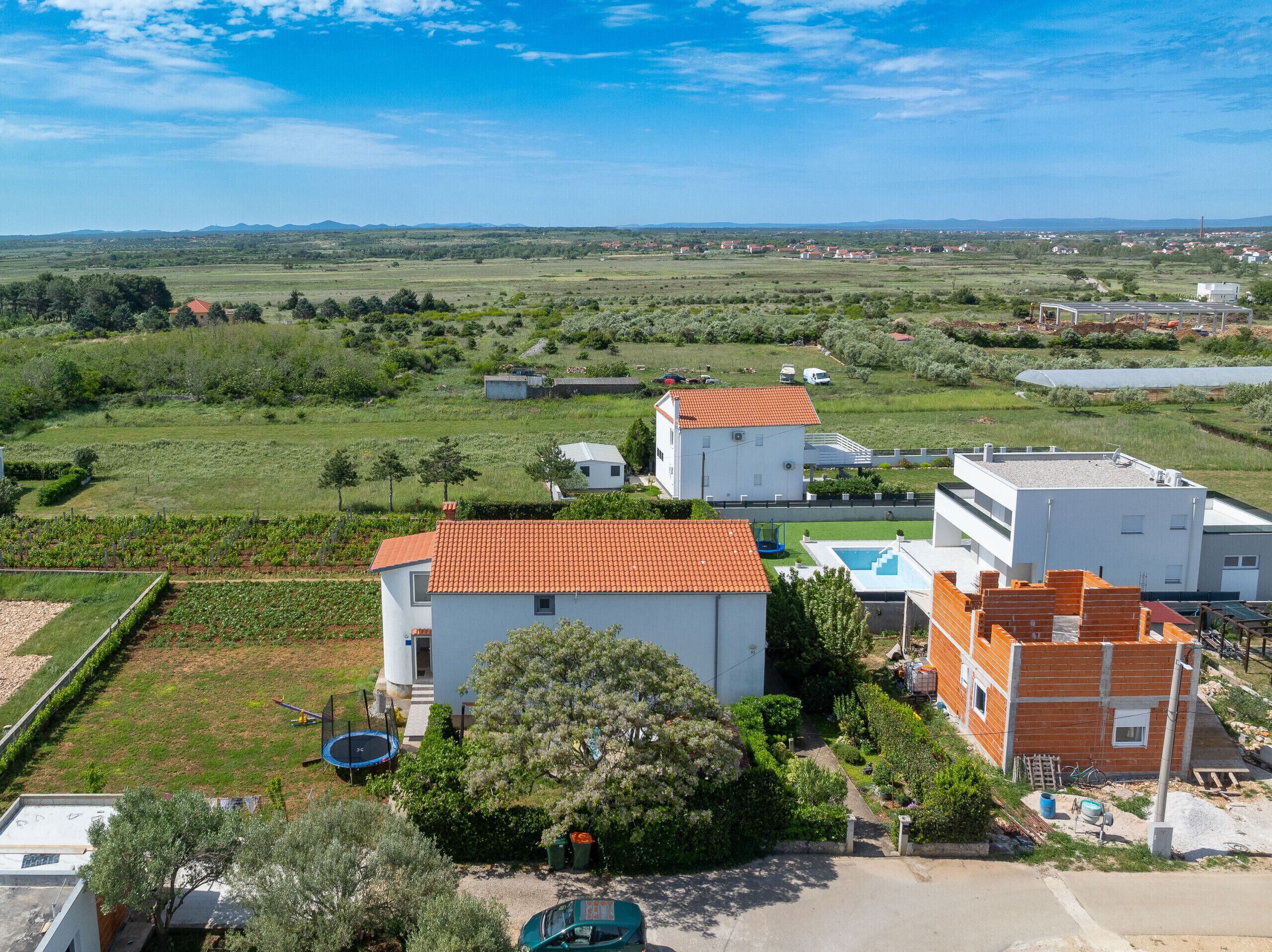 Un quartier résidentiel avec des maisons, une piscine et un vignoble.
