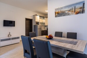 A modern kitchen with a microwave, oven, and coffee maker. - Holiday Home Ana Maria by the Beach (Vir)