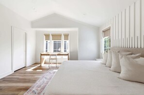 A bedroom with a large bed, a desk, and a window. - Goodwin Glow - Walk to Lake Michigan & Pool (Union Pier)