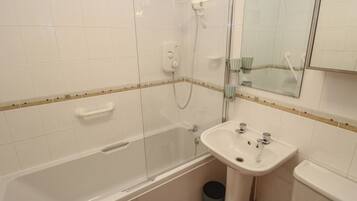 A bathroom with a bathtub, a sink, a mirror, and a shower.
