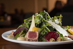 A plate of food with various vegetables and a piece of meat.