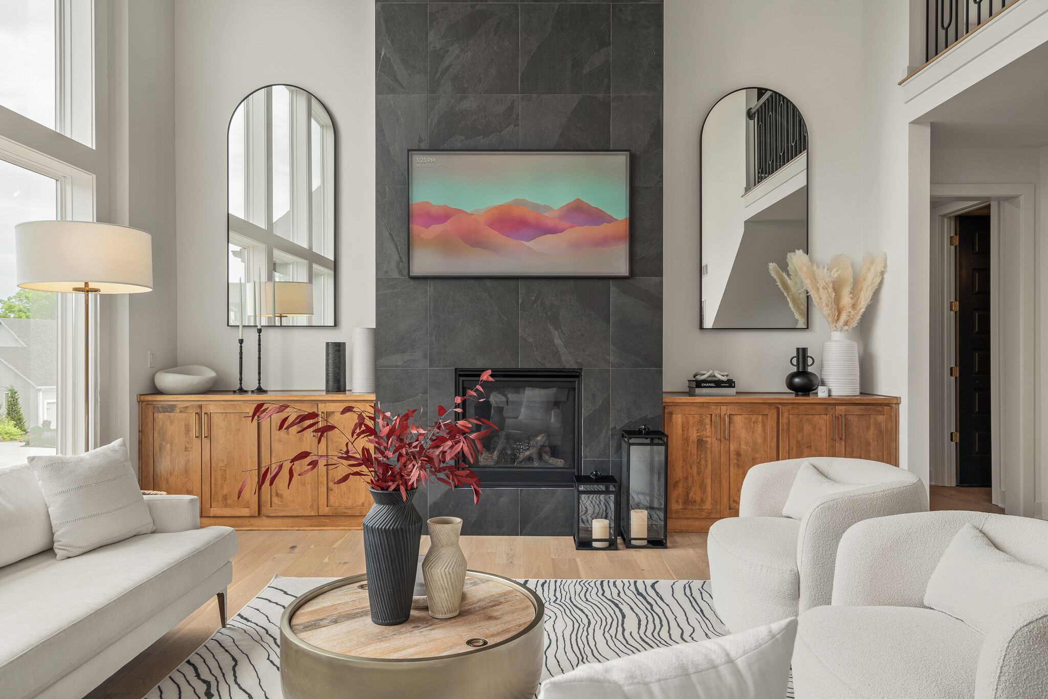 Elegant two story living room with soaring ceilings and designer finishes.