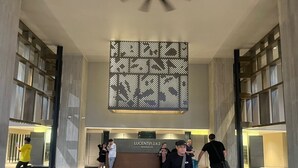 A modern hotel lobby with a reception desk labeled 'Lucentia 1&2 Residences.' - Luxury Suite Lucentia BBCC Infinity Pool (Kuala Lumpur)