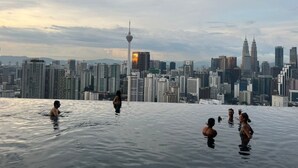 An infinity pool with a city skyline in the background. - Luxury Suite Lucentia BBCC Infinity Pool (Kuala Lumpur)