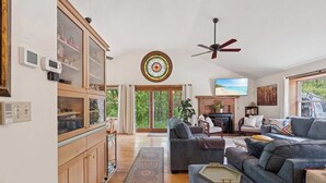 A living room with a sofa, a television, and a fireplace.