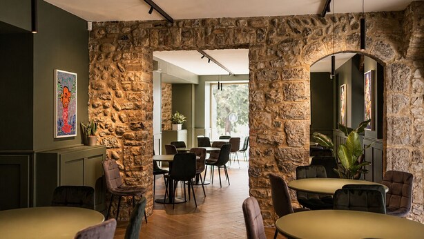 A restaurant with stone walls, wooden flooring, and modern furniture. - Boutique Hotel Roma 30 (Trescore Balneario)