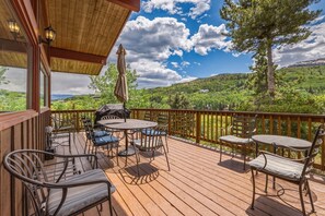 A wooden deck with outdoor furniture, a grill, and a view of a mountainous landscape. - Classic Snowmass Village Ski Chalet,  Ski-in! (Snowmass Village)