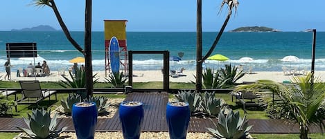 On the beach, white sand, sun-loungers, beach umbrellas