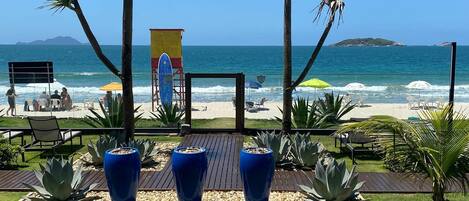 On the beach, white sand, sun loungers, beach umbrellas