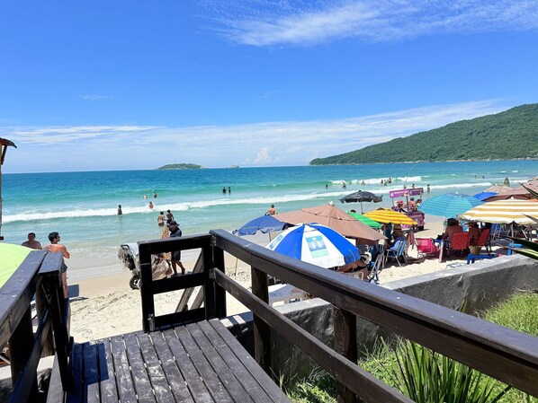 On the beach, white sand, sun loungers, beach umbrellas