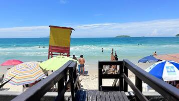 On the beach, white sand, sun loungers, beach umbrellas