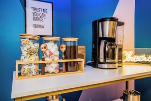 A coffee station with Tequila, Coffee Filters, and a Coffee Maker.