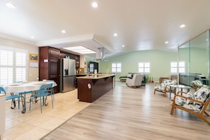 A spacious living area with a kitchen, dining table, and seating area. - Spacious 3BR San Diego Home w/ Parking & AC Modern (San Diego)