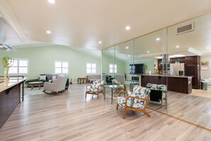 A spacious living area with a kitchen, a dining area, and a seating area with chairs and a sofa. - Spacious 3BR San Diego Home w/ Parking & AC Modern (San Diego)